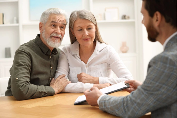 A couple discussing their will with an advisor.